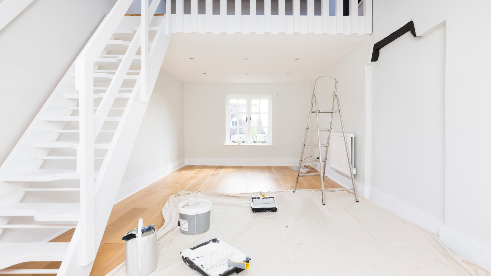 A white room with a staircase and a ladder